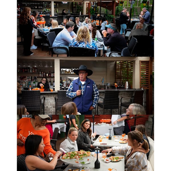 Guests enjoying pizza and drinks at Sal's Famous Pizzeria's outdoor patio, with a bartender and speaker.